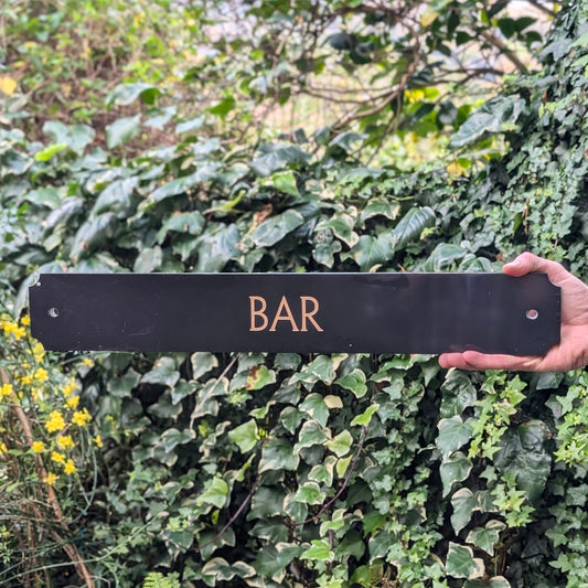 Black and Gold Bar Sign